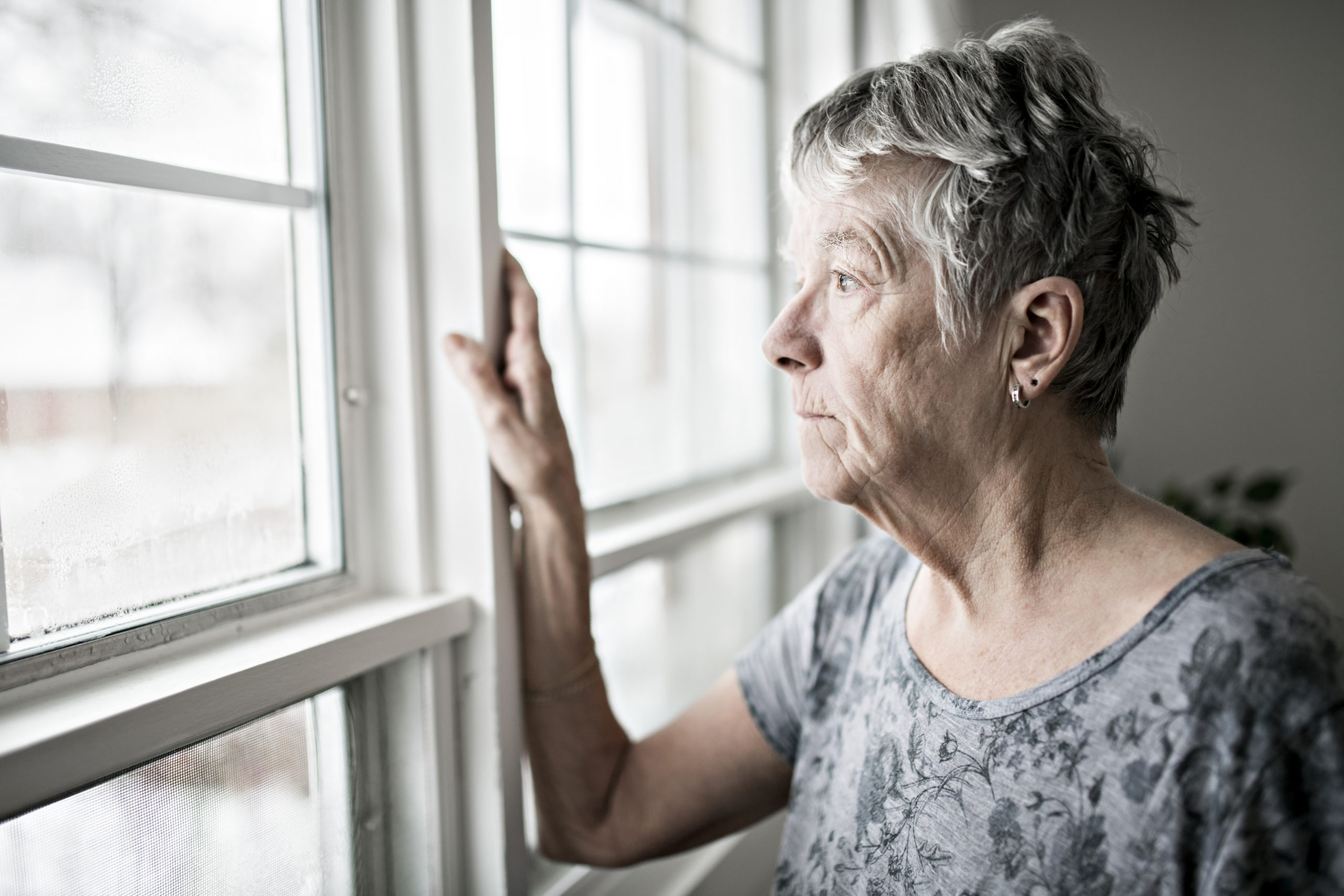 A sad lonely 70 years old senior in her apartment